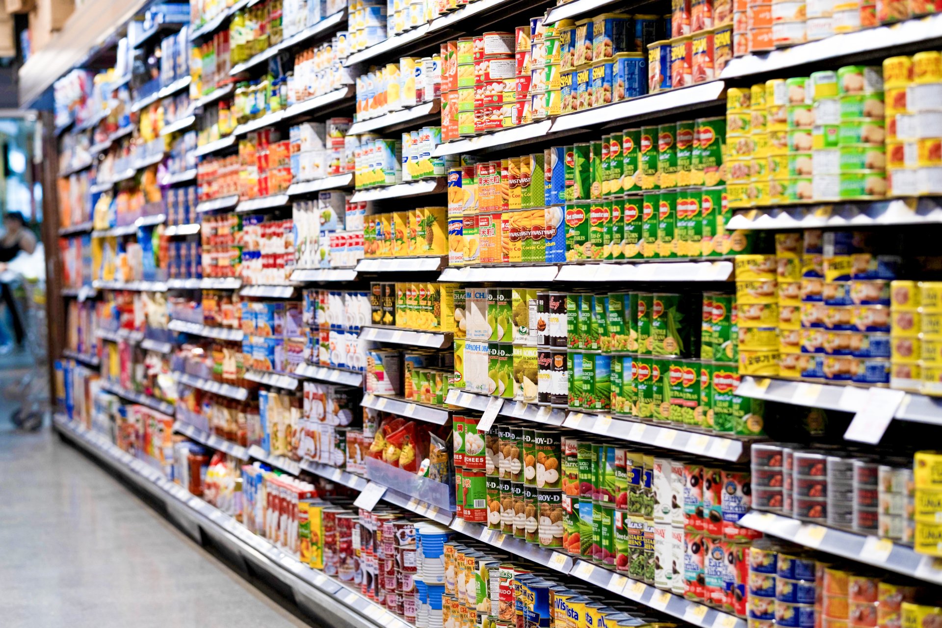 Assortment of popular canned vegetables including asparagus, beets, peppers, tomatoes and green peas