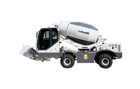 Integrated self-loading concrete mixer