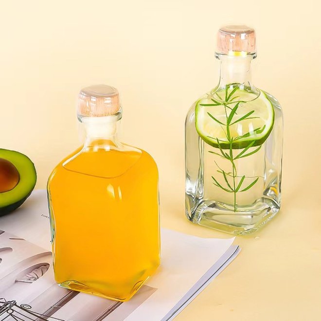 Botella de zumo de cristal de diseño con tapa